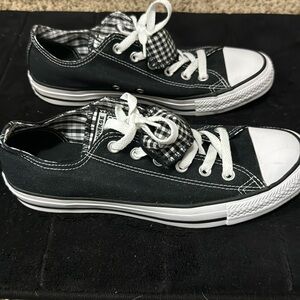 Black converse with checkered pattern on inside